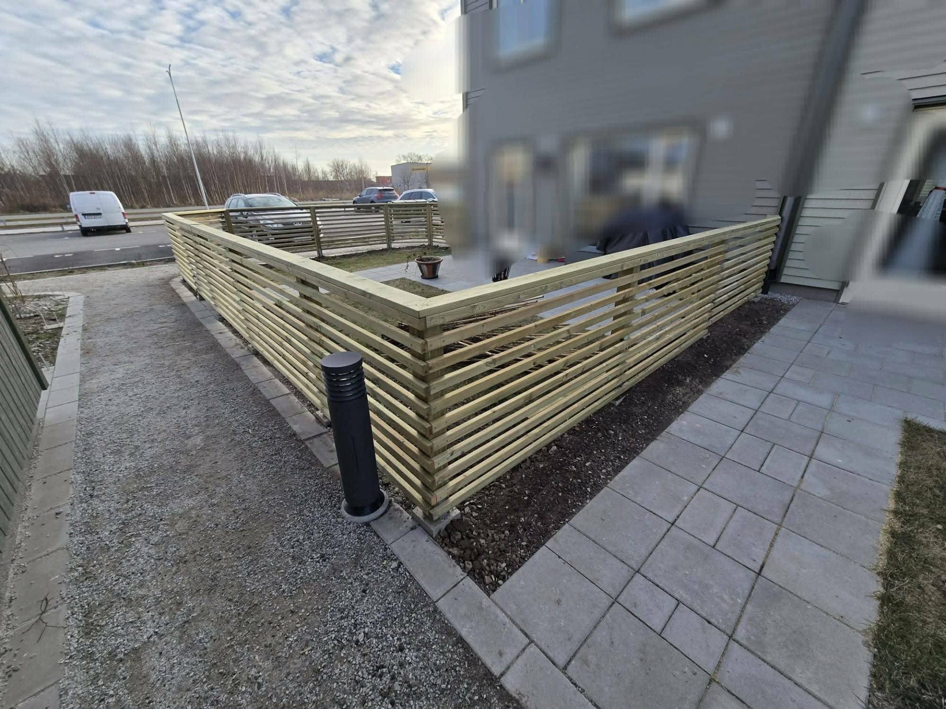 Stilrent spjälstaket som skapar en harmonisk och funktionell utemiljö.
